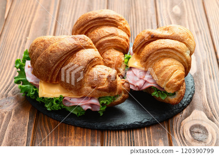 Croissant sandwich with salad ham and cheese . Top view 120390799