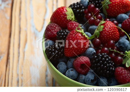 Mix of ripe colorful berries in bowl photography . Blueberry , strawberry , raspberry , blackberry and red currant . Top view Mix of ripe colorful berries in bowl photography . Blueberry , strawberry , raspberry , blackberry and red currant . Top view 120390817