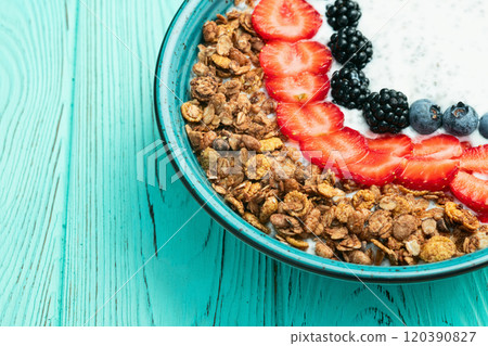 Healthy breakfast . Yogurt with berries ( strawberry , raspberry , blueberry , blackberry ) , granola and chia seeds . Top view 120390827