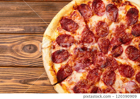 Pizza pepperoni fast food . Top view on rustic background 120390909