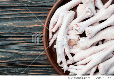 Raw chicken foot ( paws ) Top view on rustic background Raw chicken foot ( paws ) Top view on rustic background 120390936