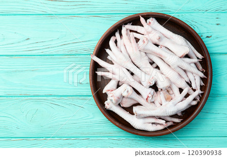Raw chicken foot ( paws ) Top view on rustic background 120390938