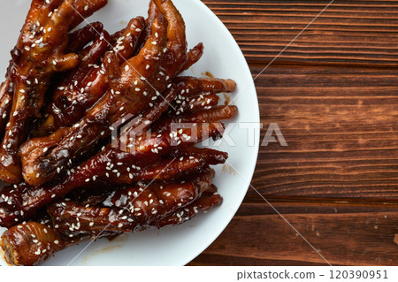 Caramelized korean or Chinese chicken foots ( paws ) with sesame . Top view Caramelized korean or Chinese chicken foots ( paws ) with sesame . Top view 120390951