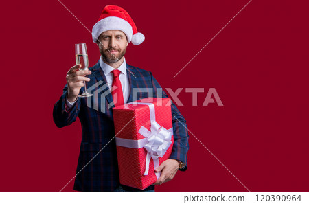 businessman celebrate xmas isolated on red, copy space. xmas businessman with present celebrate. businessman celebrate xmas isolated on red, copy space. xmas businessman with present celebrate. 120390964