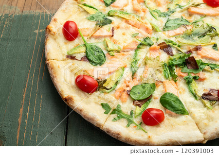Italian pizza with avocado salmon tomatoes and mozzarella photography. top view Italian pizza with avocado salmon tomatoes and mozzarella photography. top view 120391003