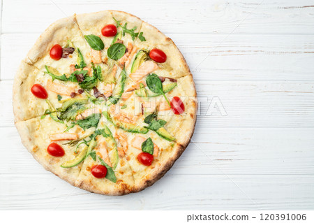 Italian pizza with avocado salmon tomatoes and mozzarella photography. top view Italian pizza with avocado salmon tomatoes and mozzarella photography. top view 120391006