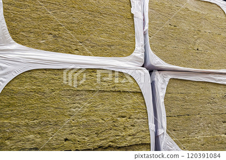 stack of glass wool insulation stacks in whie shrink wrap 120391084