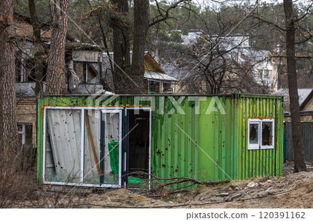 Cities of Ukraine after the Russian occupation. Destroyed buildings on the streets of Irpen. Broken, shelled windows. Buildings after being hit by missiles. Cities of Ukraine after the Russian occupation. Destroyed buildings on the streets of Irpen. Broken, shelled windows. Buildings after being hit by missiles. 120391162