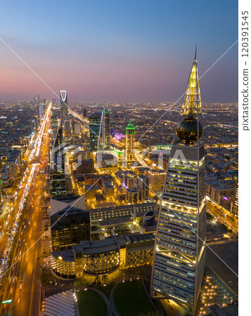 Al Faisaliah Tower pyramid-shaped commercial skyscraper. Riyadh. Drone shot flying. Sunset. Evening. 120391545