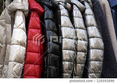 many winter goose feather jackets hanging in a shop many winter goose feather jackets hanging in a shop 120391690