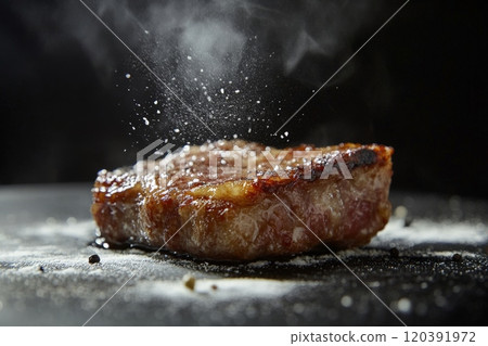 Steaming grilled steak with salt sprinkle close-up 120391972