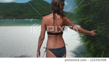 Young woman in bikini walking Malibu beach, Thailand, Koh Phangan Island. Female back view enjoy seascape and white sand shore landscape. Relax, outdoor lifestyle travel, summer holiday vacation Young woman in bikini walking Malibu beach, Thailand, Koh Phangan Island. Female back view enjoy seascape and white sand shore landscape. Relax, outdoor lifestyle travel, summer holiday vacation 120392496