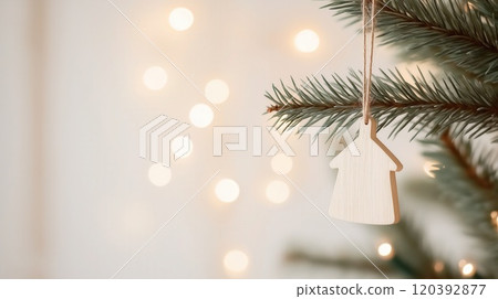 Minimal wooden house ornament realty copy space hanging on pine tree branch soft golden lights 120392877