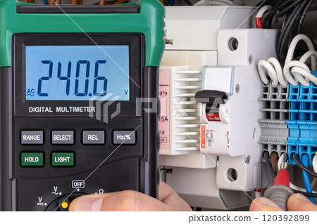 Voltage Measurement with Digital Multimeter in Electrical Panel 120392899