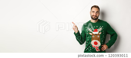 Winter holidays and christmas. Thoughtful bearded man thinking, having an idea and pointing finger at upper left corner, white background Winter holidays and christmas. Thoughtful bearded man thinking, having an idea and pointing finger at upper left corner, white background 120393011