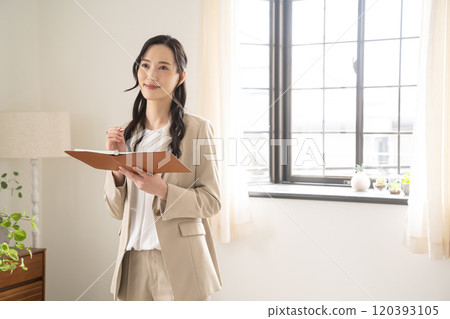Businesswoman reading documents in a room 120393105
