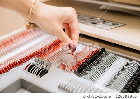 Optometrist selecting trial lens from a lens set for precise vision correction and testing Optometrist selecting trial lens from a lens set for precise vision correction and testing 120393916