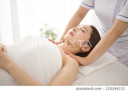 Woman receiving a massage from an esthetician 120394151