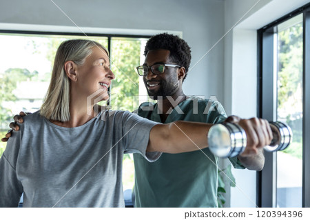 African american doctor having rehabilitation exercises with a female patient African american doctor having rehabilitation exercises with a female patient 120394396
