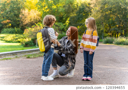 School-age kids in volunteer activity with teacher in park 120394655