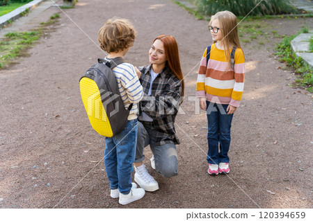 School-age kids in volunteer activity with teacher in park School-age kids in volunteer activity with teacher in park 120394659
