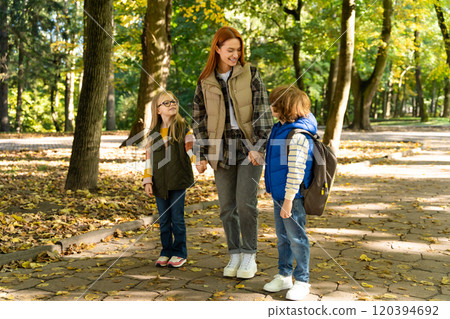 School-age kids enjoying carefree time together in park with camp teacher feeling joyful attitudes School-age kids enjoying carefree time together in park with camp teacher feeling joyful attitudes 120394692