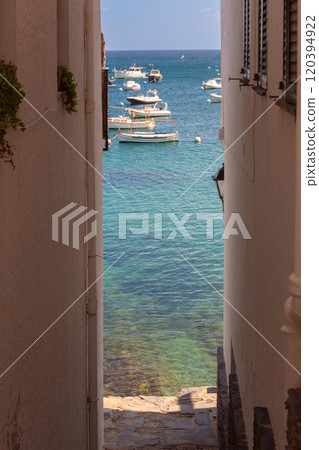 View of boats through a narrow street, Cadaques, Spain 120394922