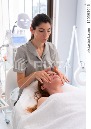 Woman receiving serum oil treatment in beauty 120395046