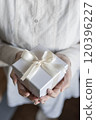 A woman giving a gift 120396227