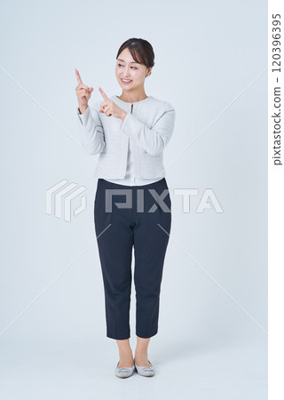 A businesswoman posing to guide or point out A businesswoman posing to guide or point out 120396395