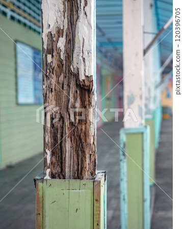 The wooden pole is decayed and waiting to be repaired. 120396705