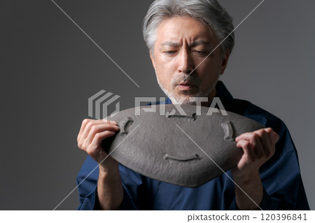 Image of a male potter holding a plate Image of a male potter holding a plate 120396841