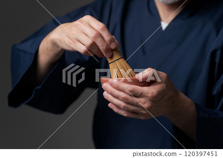 Senior man's hands making tea 120397451