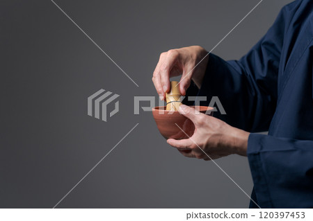 Senior man's hands making tea Senior man's hands making tea 120397453