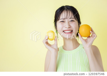 Beauty image: A woman holding fruit 120397546
