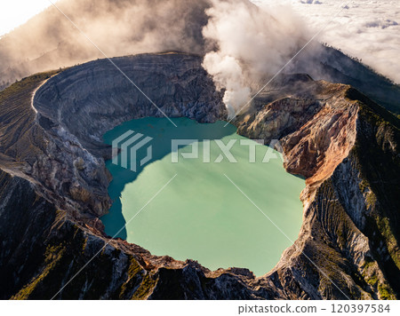 Aerial view Kawah Ijen volcano with turquoise sulfur water lake at sunrise.Amazing nature landscape view at East Java, Indonesia. Natural landscape background Aerial view Kawah Ijen volcano with turquoise sulfur water lake at sunrise.Amazing nature landscape view at East Java, Indonesia. Natural landscape background 120397584