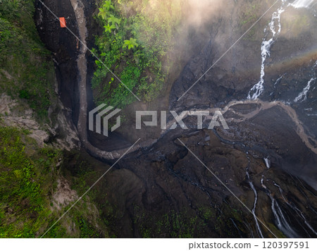 Aerial view of Panorama Tumpak Sewu Waterfalls also known as Coban Sewu.Beautiful rainbow and fog,Tumpak Sewu Waterfalls are a tourist attraction in East Java, Indonesia.Amazing travel destination Aerial view of Panorama Tumpak Sewu Waterfalls also known as Coban Sewu.Beautiful rainbow and fog,Tumpak Sewu Waterfalls are a tourist attraction in East Java, Indonesia.Amazing travel destination 120397591