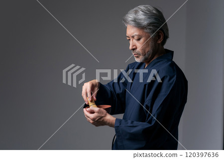 Senior man making tea 120397636