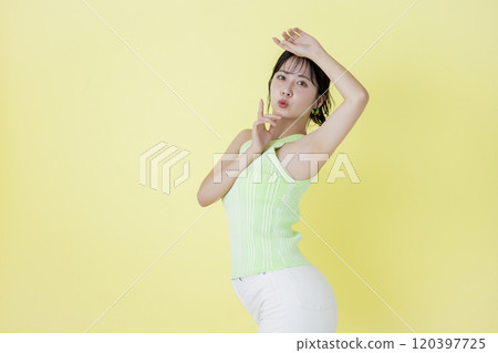 Summer image, yellow background, portrait of a young woman wearing a tank top Summer image, yellow background, portrait of a young woman wearing a tank top 120397725
