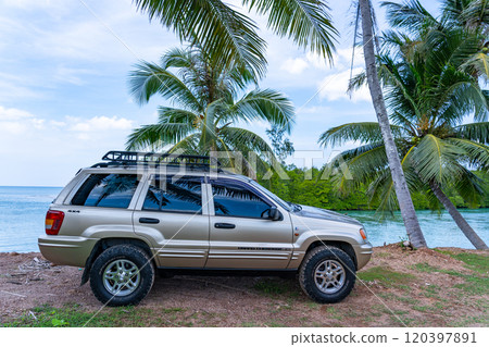 Phuket Thailand November 19, 2024: Brown American SUV Jeep Grand Cherokee WJ 2002 near the sea in Phuket Thailand,Off-road over land,View of the sea and dirt road nature landscape Phuket Thailand November 19, 2024: Brown American SUV Jeep Grand Cherokee WJ 2002 near the sea in Phuket Thailand,Off-road over land,View of the sea and dirt road nature landscape 120397891