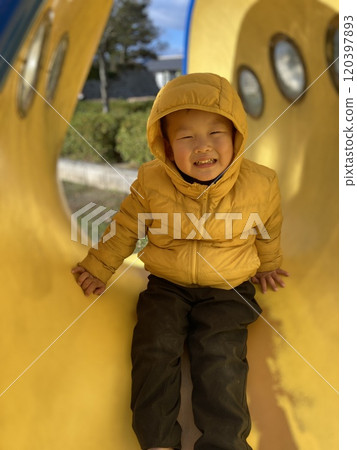 A boy playing in a park 120397893