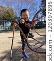 A boy playing in a park 120397895