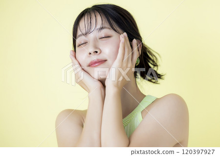 Summer image, yellow background, portrait of a young woman wearing a tank top Summer image, yellow background, portrait of a young woman wearing a tank top 120397927