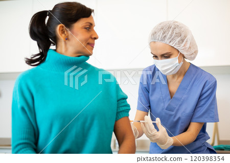 Nurse making injection of covid-19 vaccine 120398354