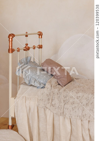 A bed with a white headboard and a blue pillow A bed with a white headboard and a blue pillow 120399538