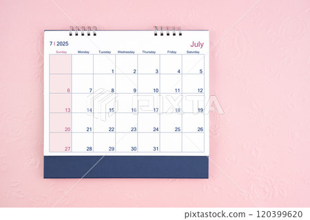 Directly above view of July 2025 desk calendar on pink background. Directly above view of July 2025 desk calendar on pink background. 120399620