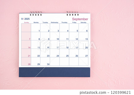 Directly above view of September 2025 desk calendar on pink background. 120399621