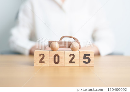 Happy New Year 2025 with Car model on table. Automobile Tax, Car Insurance, Financial, vehicle Repair and Maintenance and New Year concept 120400092