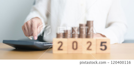 Happy New Year 2025 with Coins stack and calculator. Money, Budget, tax, investment, financial, savings and New Year Resolution concepts 120400116