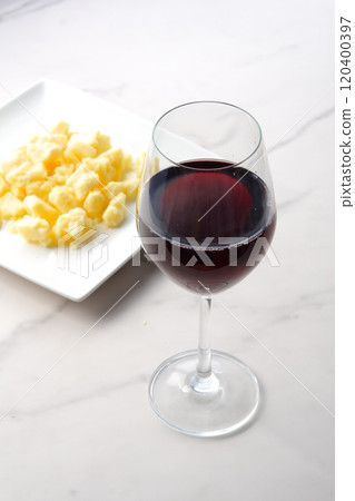 Glass of red wine and Gouda cheese 120400397